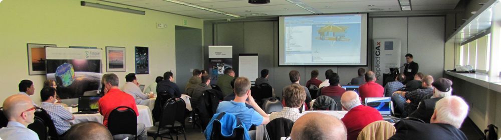 Large group of people in a classroom with a femap tutorial on the board at the front of the room - Applied CAx Siemens software partner USA