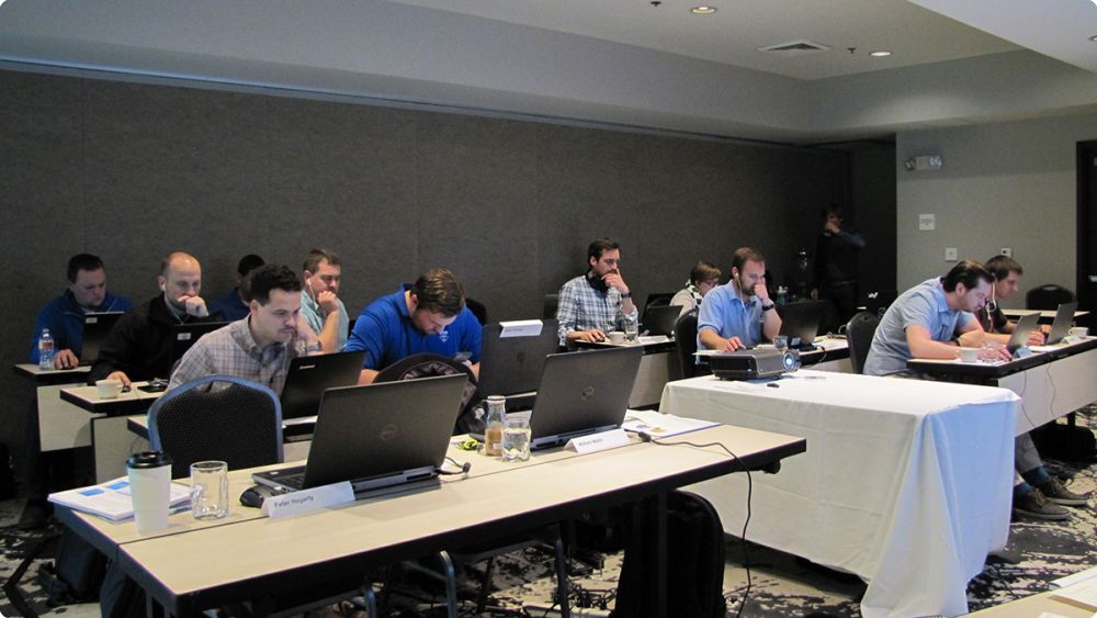 Group of people in a classroom working on their computers - Applied CAx Siemens software partner USA