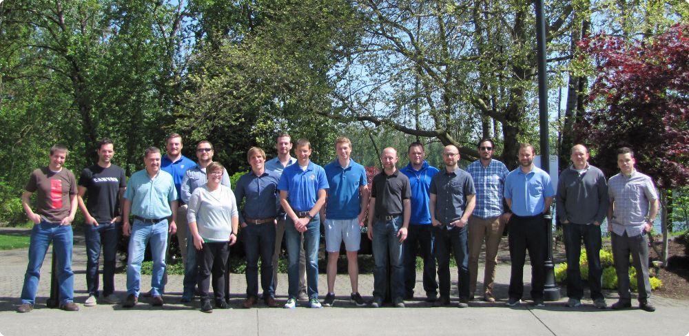 Group of 17 people smiling at the camera and standing outside - Applied CAx Siemens software partner USA