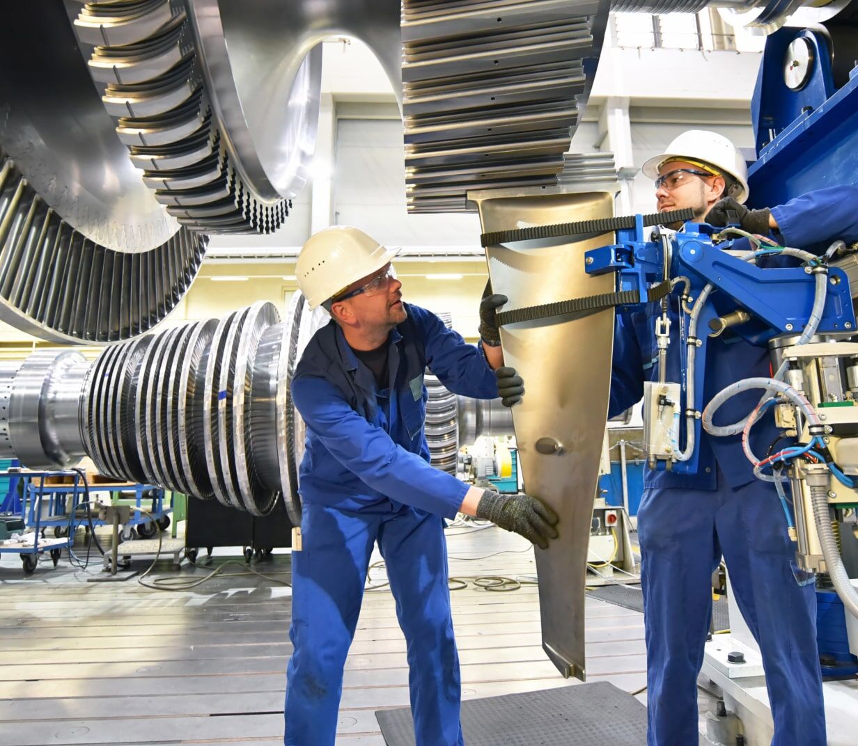 two people working on a metal object - Applied CAx Siemens software partner USA